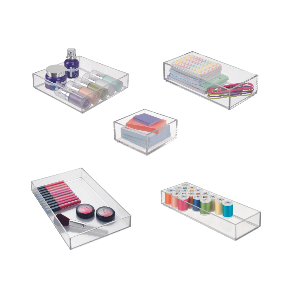 Transparent storage boxes with cosmetics, pens, yarn, and rubber bands in the room.