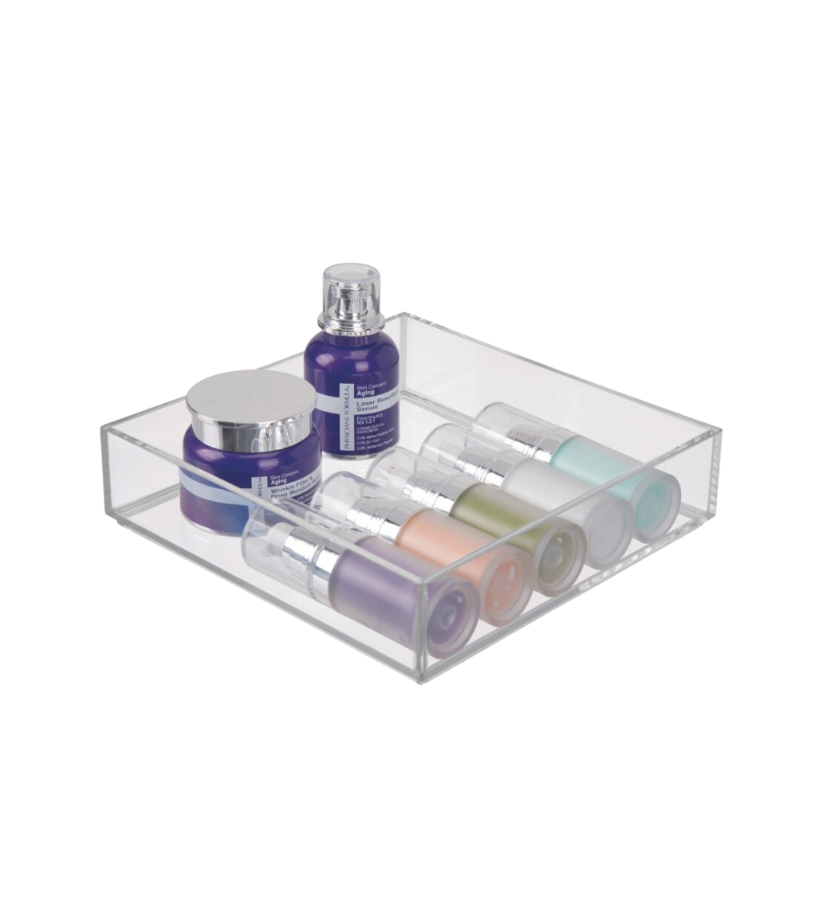 Clear container with colorful cosmetic bottles and jars on a white surface.
