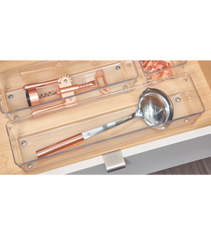 The LINUS - HIGH drawer organizer from iDesign holds a metal trowel with a copper handle and corkscrew; copper clips are stored in a small compartment, keeping your kitchen drawer tidy.