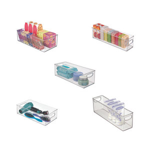 Five iDesign BINZ storage containers, CLEAR, extra long and stackable, neatly display stored household items such as food, cosmetics, household appliances, and bottles against a white background.
